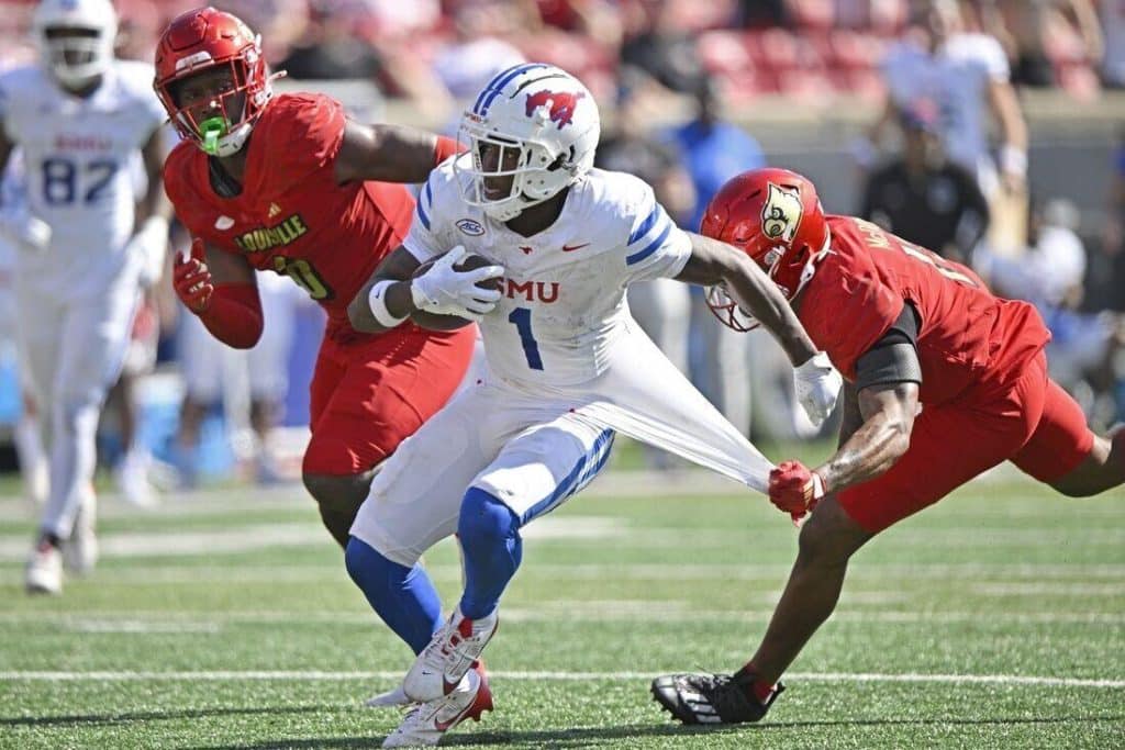 Southern Methodist Mustangs running back Brashard Smith (1) runs the ball against Louisville Cardinals defensive back Tamarion McDonald (12) during the second half at L&N Federal Credit Union Stadium